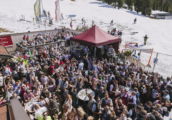 Eine große Menschengruppe feiert zusammen im Freien.
