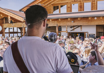 Ein Mann spielt Gitarre und sing für ein Publikum.